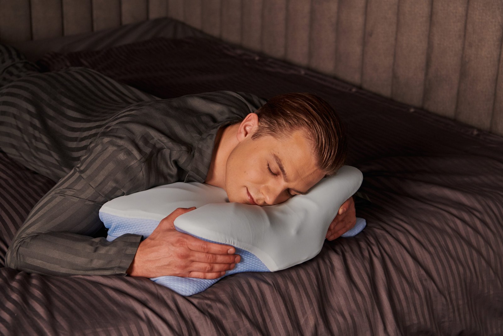 Stomach sleeper using ergonomic pillow